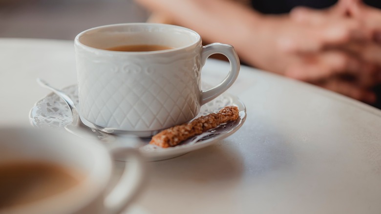 White coffee mug and biscotti 