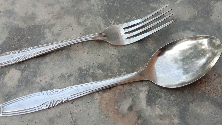 fork and spoon on concrete