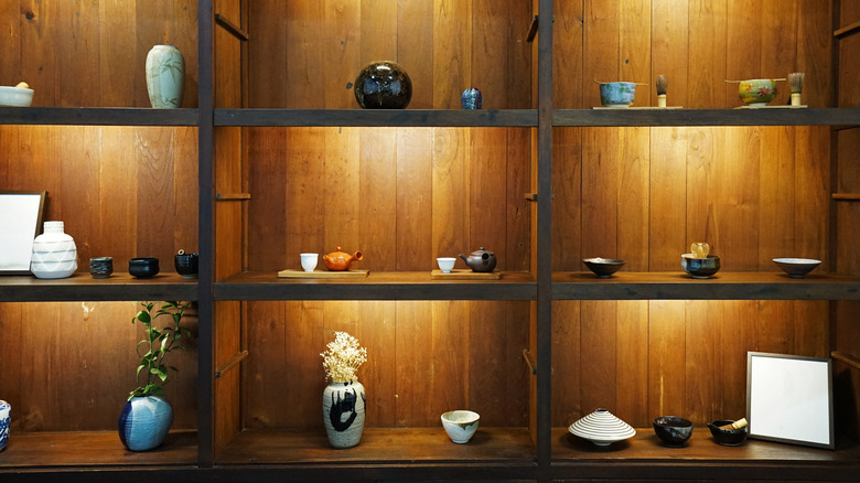 display case with pottery