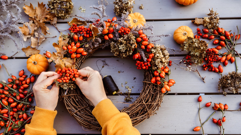 Woman crafting autumn wreath 