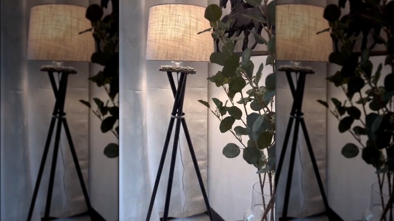 tripod lamp in a corner