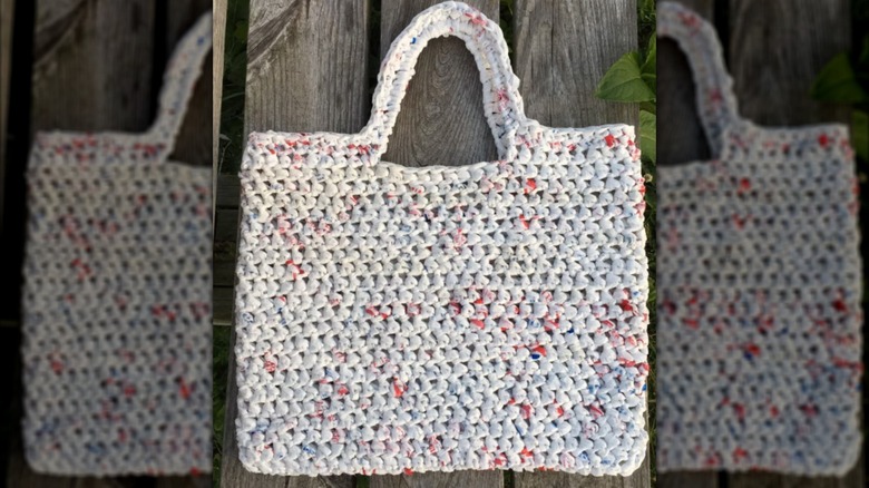 white crocheted bag with handles made from plarn