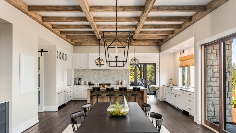 dining room with wood beams