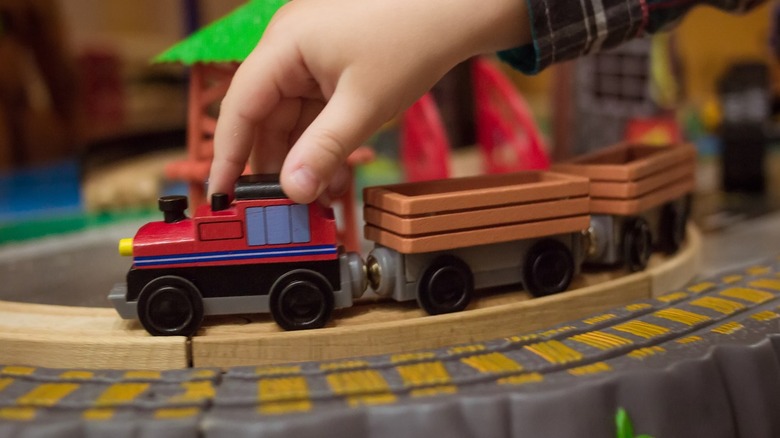 Child playing with toy train