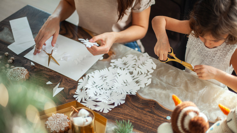 people making paper snowflakes