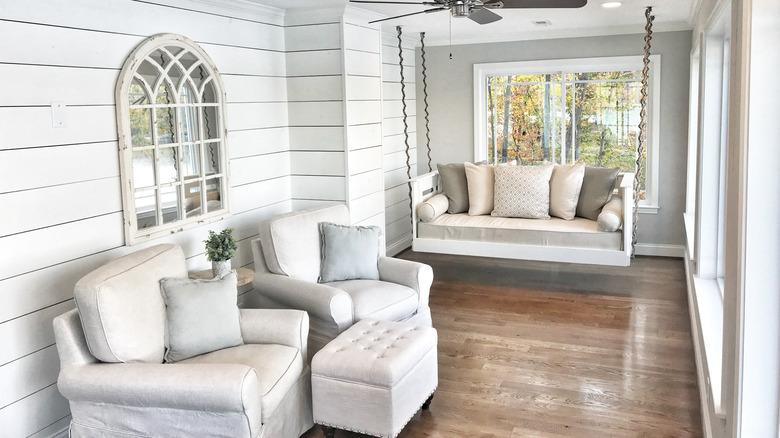 rustic sunroom with shiplap walls