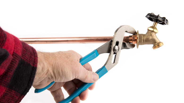 plumber using a slip joint plier