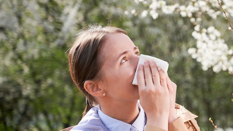 woman blowing nose