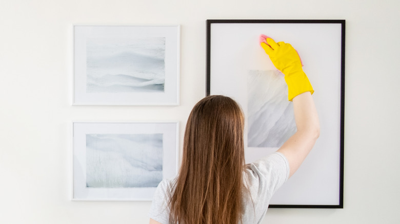 woman cleaning art