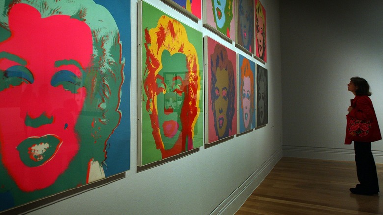 person looking at wall of pop art