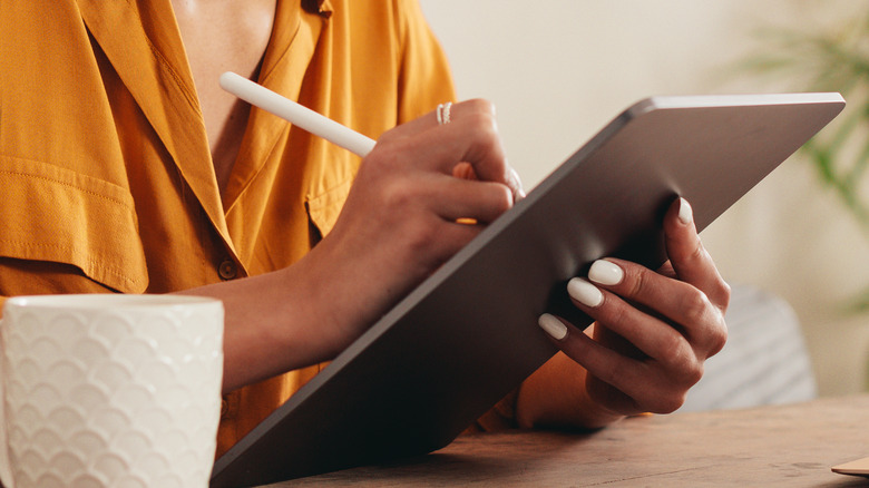 Woman sketching in notebook