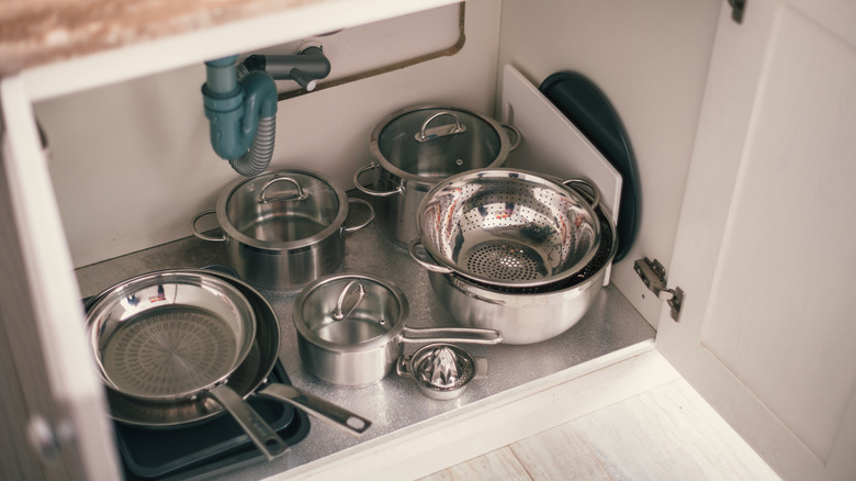 Pots and pans in kitchen cabinet