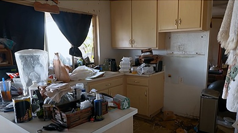 Messy kitchen with yellow cabinets