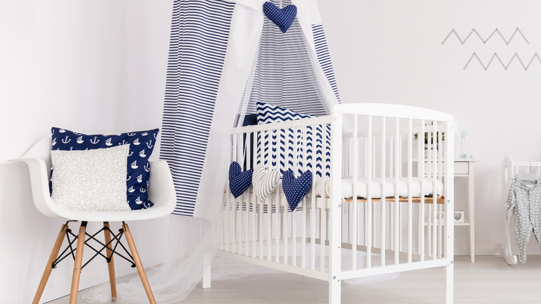 striped canopy over white crib