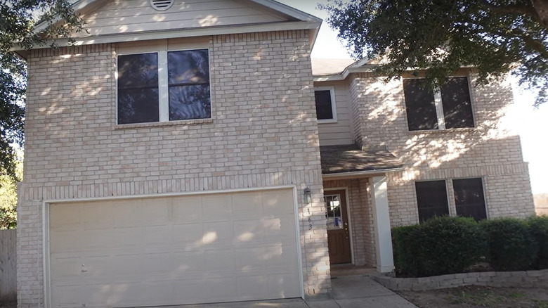 beige, brick house with garage