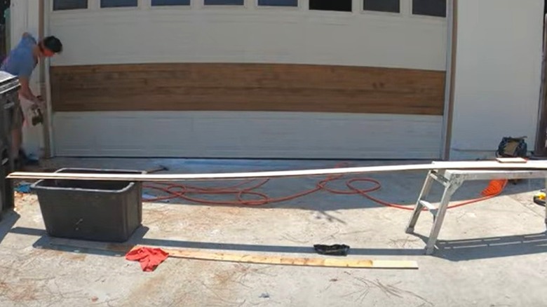 man installing panels on garage