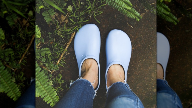 Person wearing sloggers garden clogs in a garden