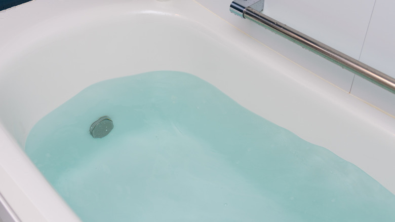 bathtub partially filled with water