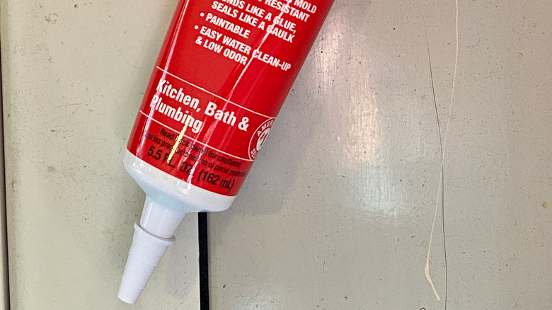 Squeezable tube of caulk 