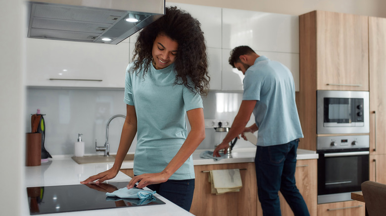 Couple cleaning kitchen