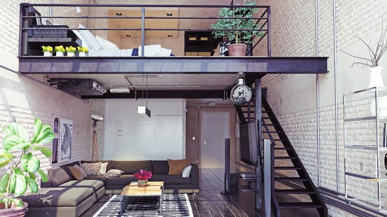 Lofted bed in industrial-style apartment