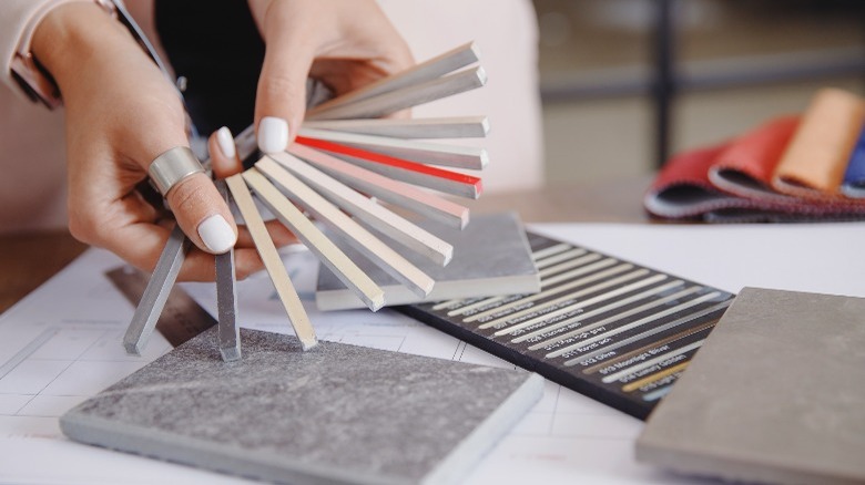 Woman holding colored grout samples