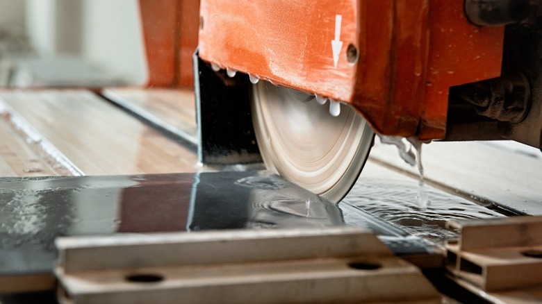 Wet saw cutting a tile