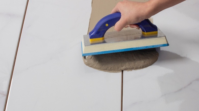 Applying grout with rubber float