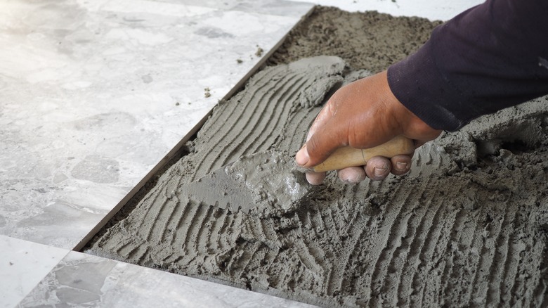 Hand applying mortar with a trowel