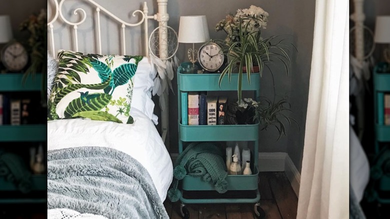 teal storage cart by bed