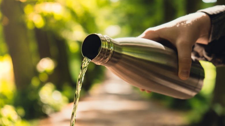 pouring water out metal bottle