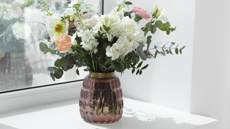 pink glass vase with flowers