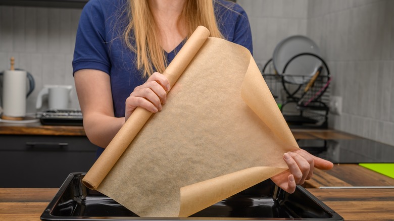 person holding parchment paper roll