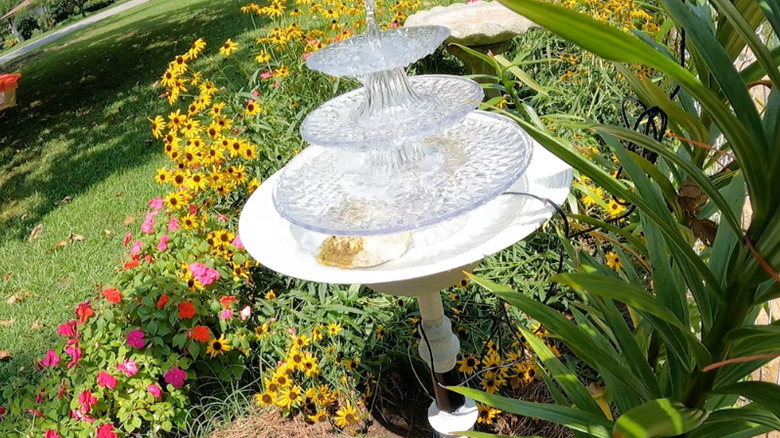 Bird bath made from an old floor lamp