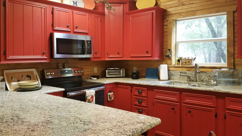 Red cabinets with granite counter