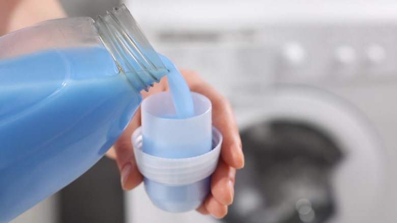 Pouring fabric softener in cap