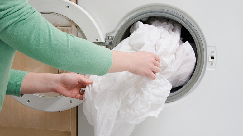 Putting bed sheet in washer