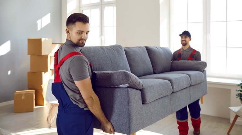 two movers moving a couch