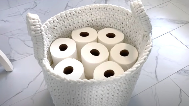 White basket with toilet paper