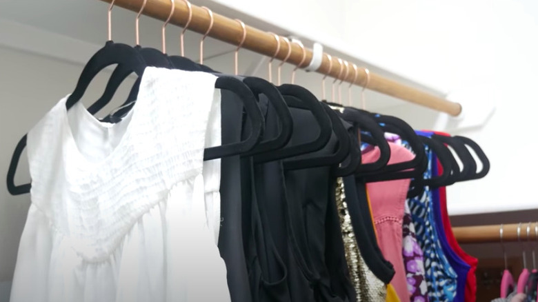 Organized clothes on black hangers