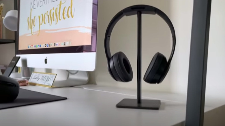 Headphones stand on a desk