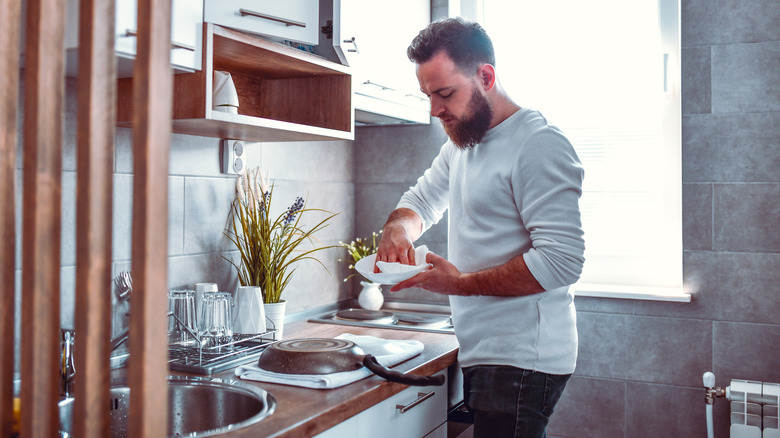 Man washing dishes