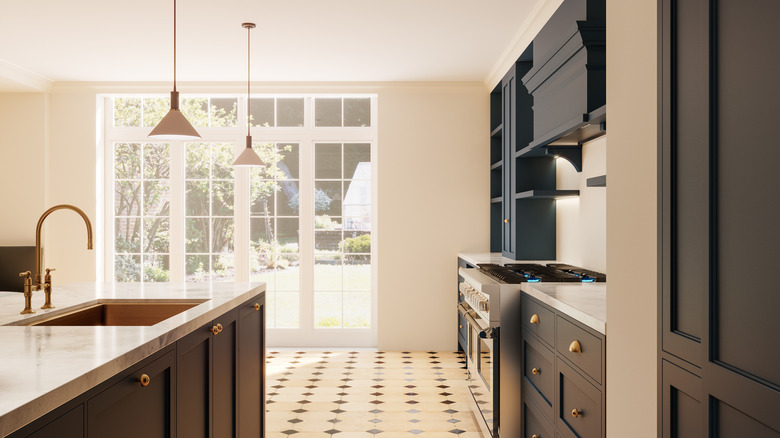 copper sink with blue cabinets