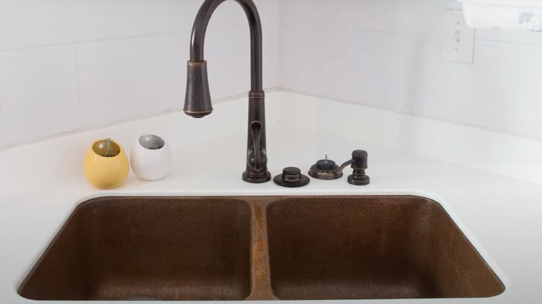 copper sink with white backsplash