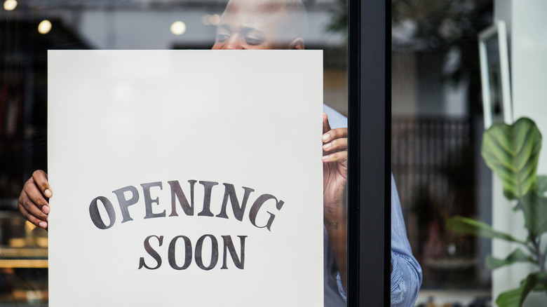 Business with "opening soon" sign in window