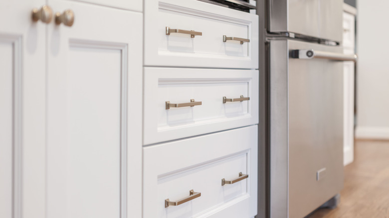 Brass hardware on kitchen cabinets