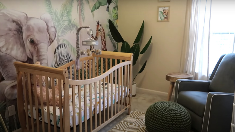 safari wallpaper behind white crib