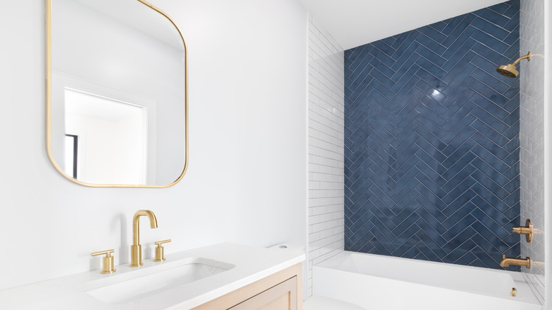 shower with blue herringbone tile