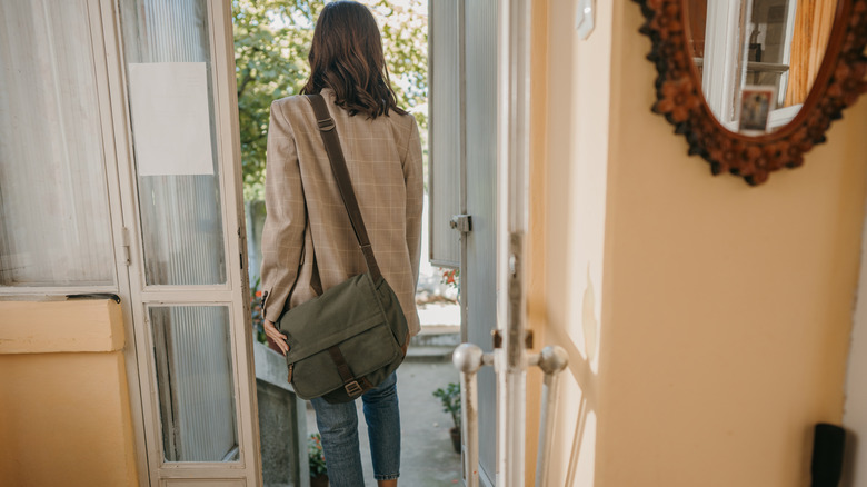 Woman walking out the front door