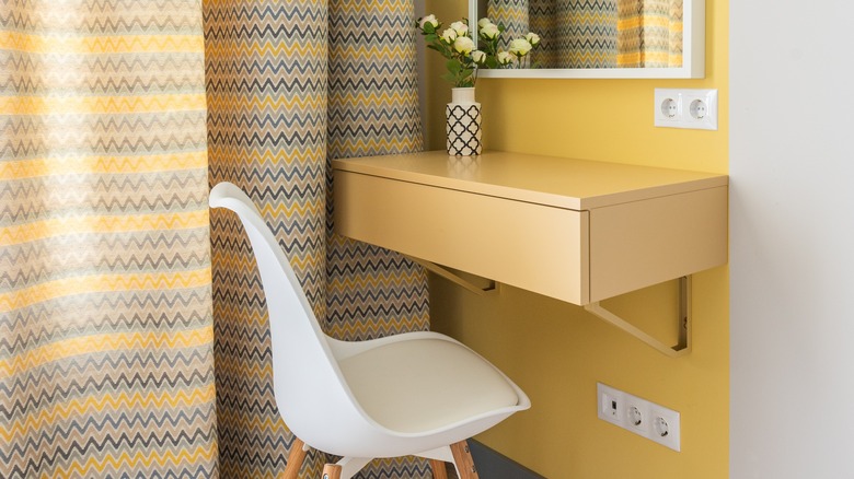 Yellow patterned curtains near desk